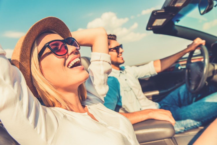 couple driving having the time of their life
